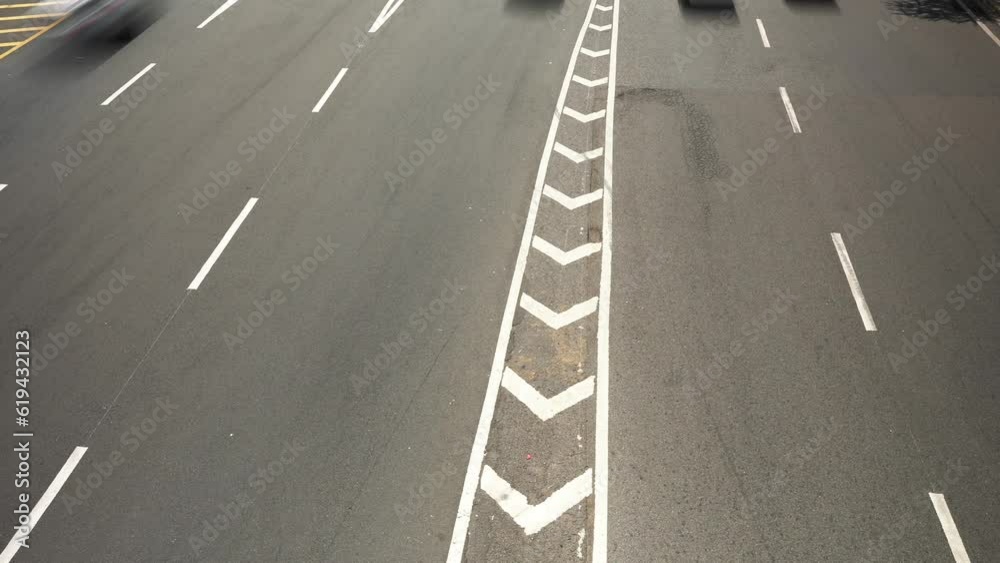 Top timelapse view of many cars and trucks driving fast on the asphalt speed multi lane road. Blur motion city traffic background Top timelapse view of many cars and trucks driving fast on the asphalt speed multi lane road. Blur motion city traffic background