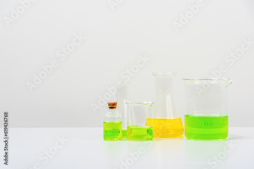 some test tube on the white table  with beakers, flasks, and test tubes filled with colorful liquids