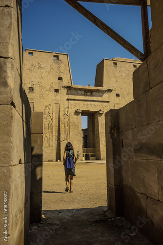 A young tourist arriving at the beautiful Edfu Temple near the Nile river. Egypt