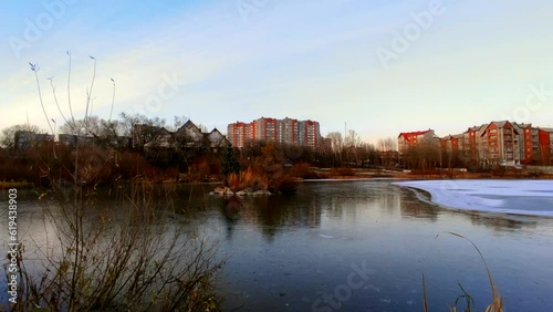 Lake half covered in ice with ducks
