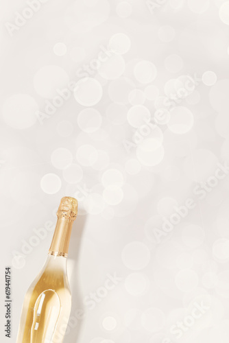 Sticker Top view sparkling white wine, bottle of champagne with bokeh on beige background, copyspace