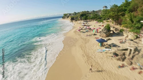 fpv drone flight over dreamland beach with whaiter sand in bali