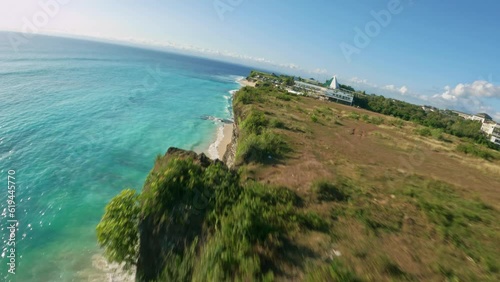 fpv drone flight over dreamland beach with whaiter sand in bali