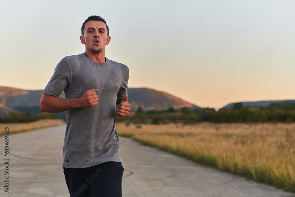 A young handsome man running in the early morning hours, driven by his commitment to health and fitness A young handsome man running in the early morning hours, driven by his commitment to health and fitness