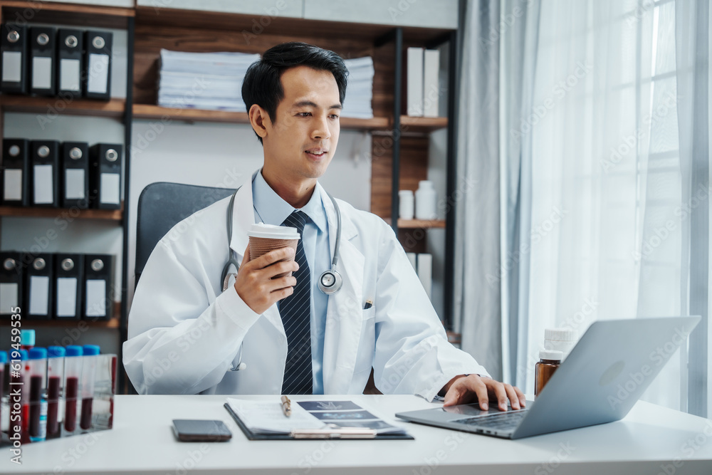 Asian medical doctors specialist in white lab coats , research or online consultation, discussing at meeting on video conference on laptop at desk in medical industry. Asian medical doctors specialist in white lab coats , research or online consultation, discussing at meeting on video conference on laptop at desk in medical industry.
