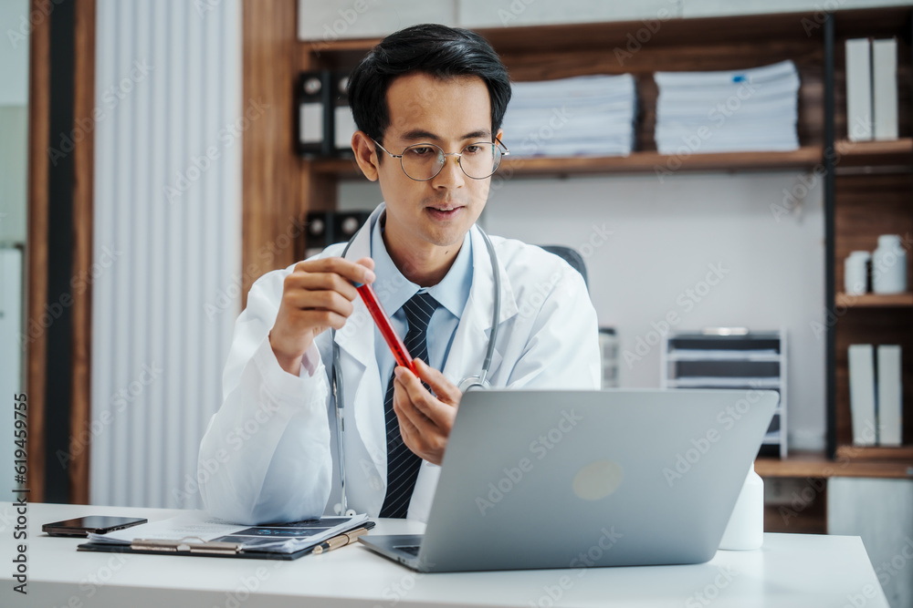 Asian medical doctors specialist in white lab coats , research or online consultation, discussing at meeting on video conference on laptop at desk in medical industry. Asian medical doctors specialist in white lab coats , research or online consultation, discussing at meeting on video conference on laptop at desk in medical industry.