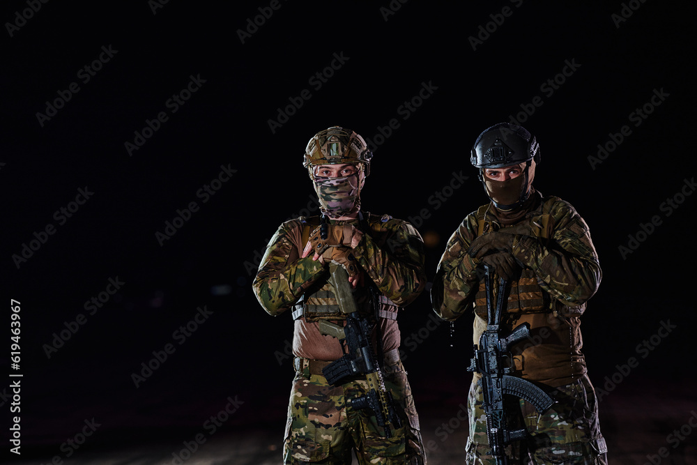 Two professional soldiers marching through the dark of night on a dangerous mission, epitomizing their unwavering bravery, unwavering teamwork, and the high-stakes intensity of their specialized