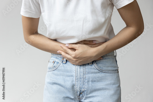 Asian Woman in Distress, Dealing with Stomachache and Digestive Health Issues