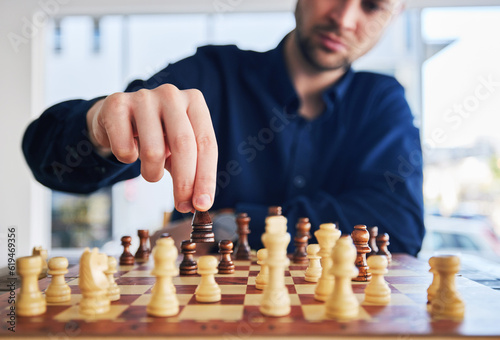 Chess, man moving a piece and game of strategy, problem solving or person playing on chessboard in competition. Planning, choice and hand on knight or king, queen and player thinking of winning move