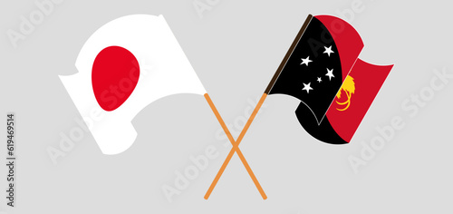 Crossed and waving flags of Japan and Papua New Guinea