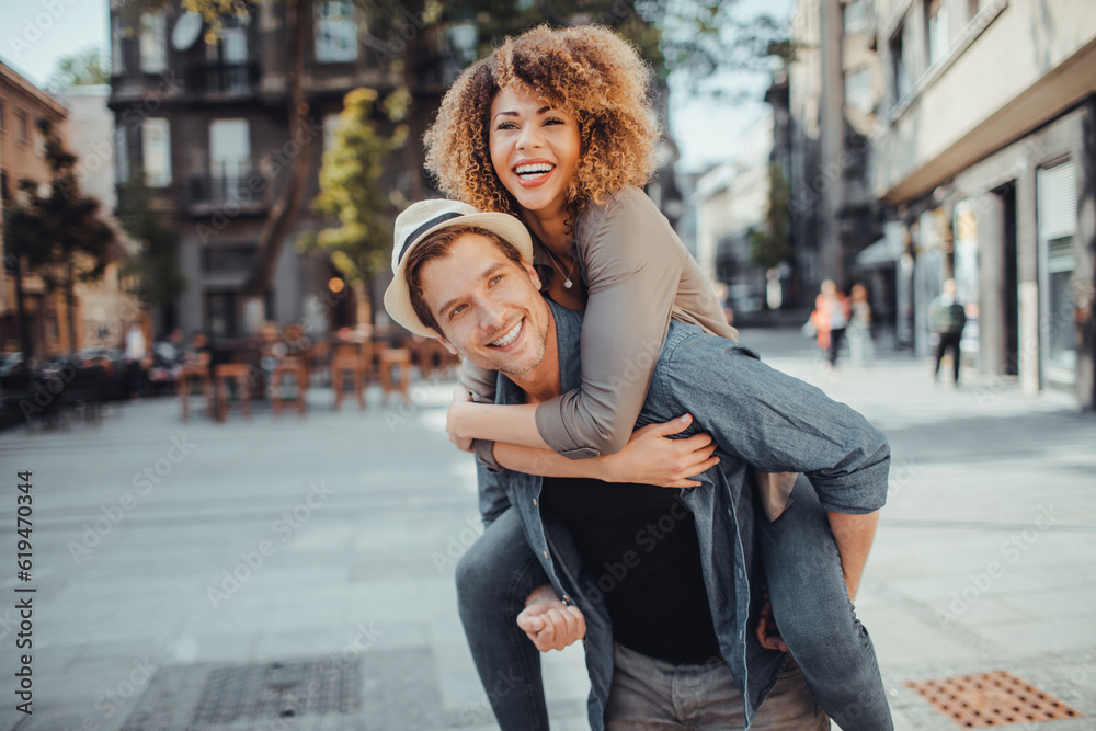 Young couple walking in the city and using a smart phone Young couple walking in the city and using a smart phone