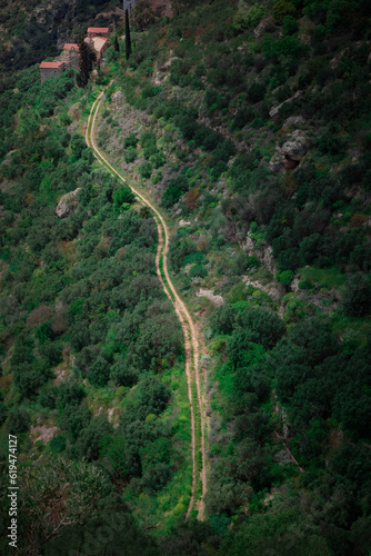 Winding road in the mountains, leading to an old house in Mani, Lakonia, Greece.