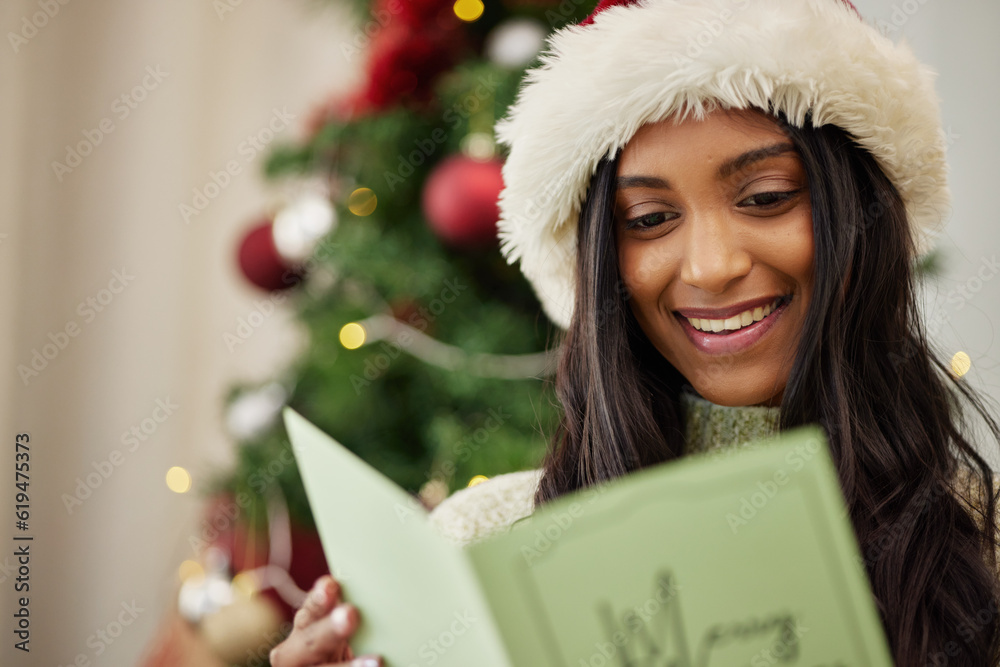 Happy woman reading Christmas card, note or message in home living room in winter holiday celebration. Smile, festive or Indian girl with emotional xmas greeting letter, wishes or kind gift in house Happy woman reading Christmas card, note or message in home living room in winter holiday celebration. Smile, festive or Indian girl with emotional xmas greeting letter, wishes or kind gift in house