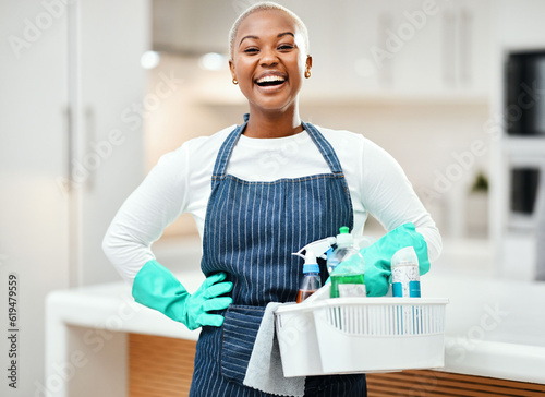 Laughing, portrait and a black woman with cleaning bucket for home service or working on dirt. Smile, start and an African worker in a house with product for housekeeping or pride in cleaner uniform photo