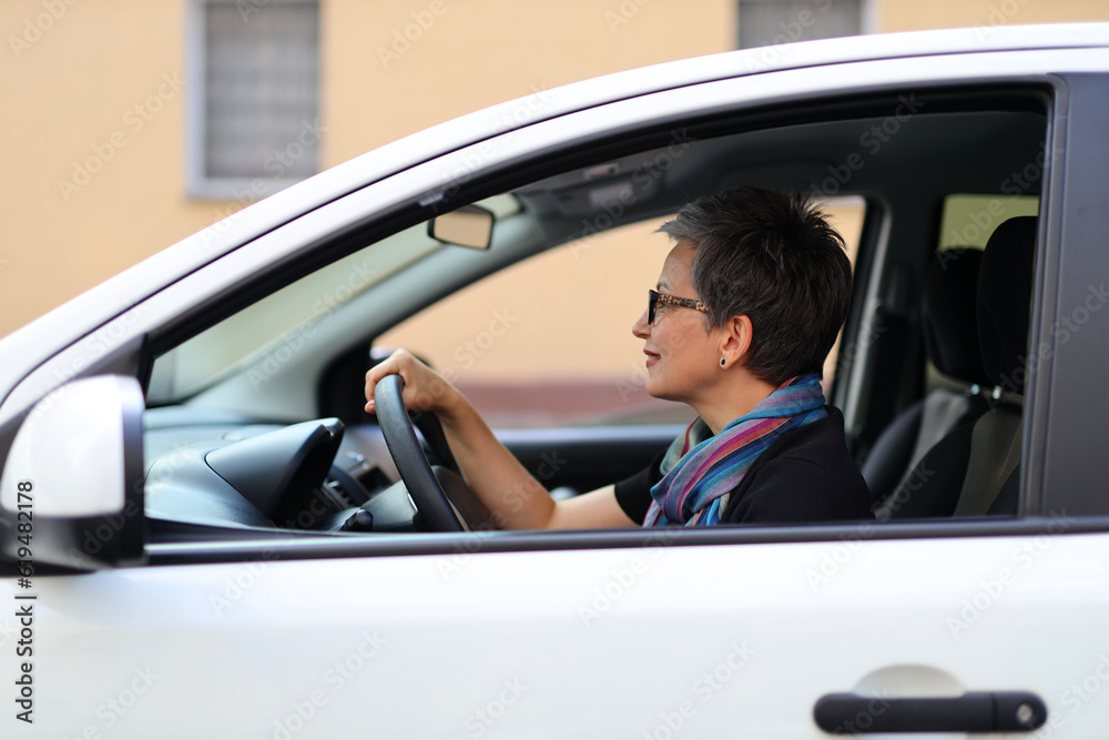 Smiling driver woman driving a car. Smiling driver woman driving a car.