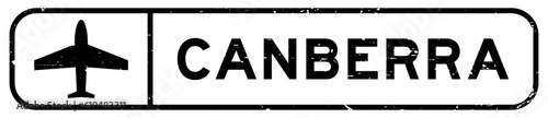 Grunge black canberra word with plane icon square rubber seal stamp on white background
