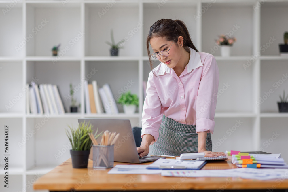 Business asian women working on laptop in office, calculating income-expenditure and analyzing real estate investment data, Accounting Financial and tax systems concept. Business asian women working on laptop in office, calculating income-expenditure and analyzing real estate investment data, Accounting Financial and tax systems concept.