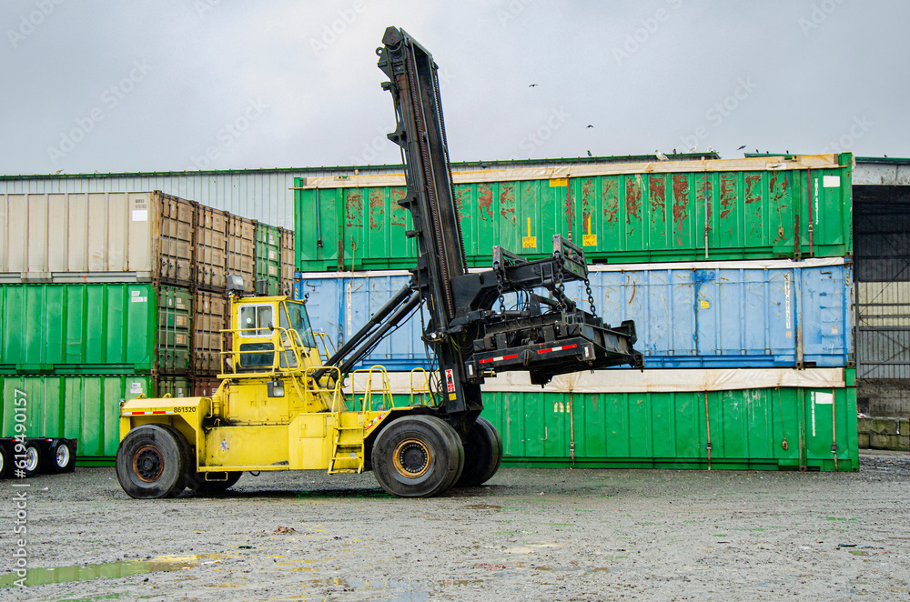 Yellow Forklift with Waste Shipping Containers