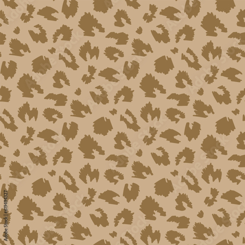 brown animalistic pattern on beige background. Vector image.