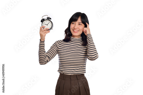 Portrait of thinking young Asian woman with sweater shirt holding alarm clock isolated on white background
