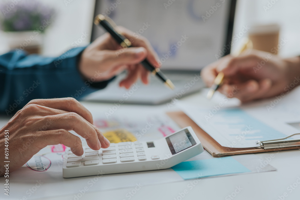 teamwork Businessman analyzing marketing plans to generate sales Analyze the graph on the table at the conference room. teamwork Businessman analyzing marketing plans to generate sales Analyze the graph on the table at the conference room.