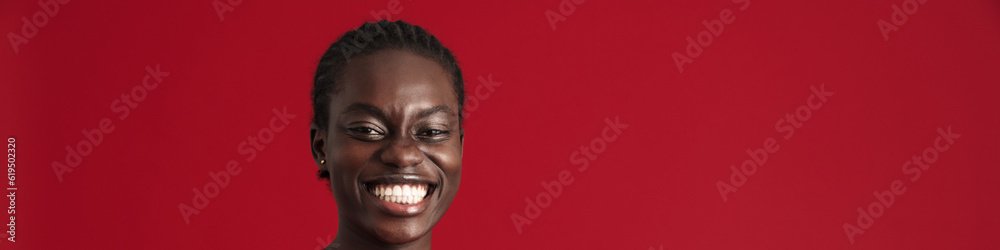 Fototapeta premium Young beautiful enthusiastic african woman with braided hair playing phone