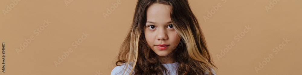 White preteen girl wearing t-shirt posing with arms crossed White preteen girl wearing t-shirt posing with arms crossed