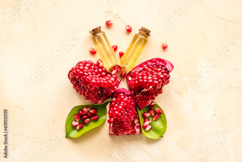Fototapeta Naklejka Na Ścianę i Meble -  Pomegranate seed oil in glass bottle with pomegranate fruit. Natural cosmetic and treatment