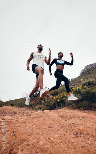 Running, jump and couple in mountain with fitness workout and training on a race and marathon. Runner, young people and road on a exercise challenge outdoor with sport cardio performance in nature