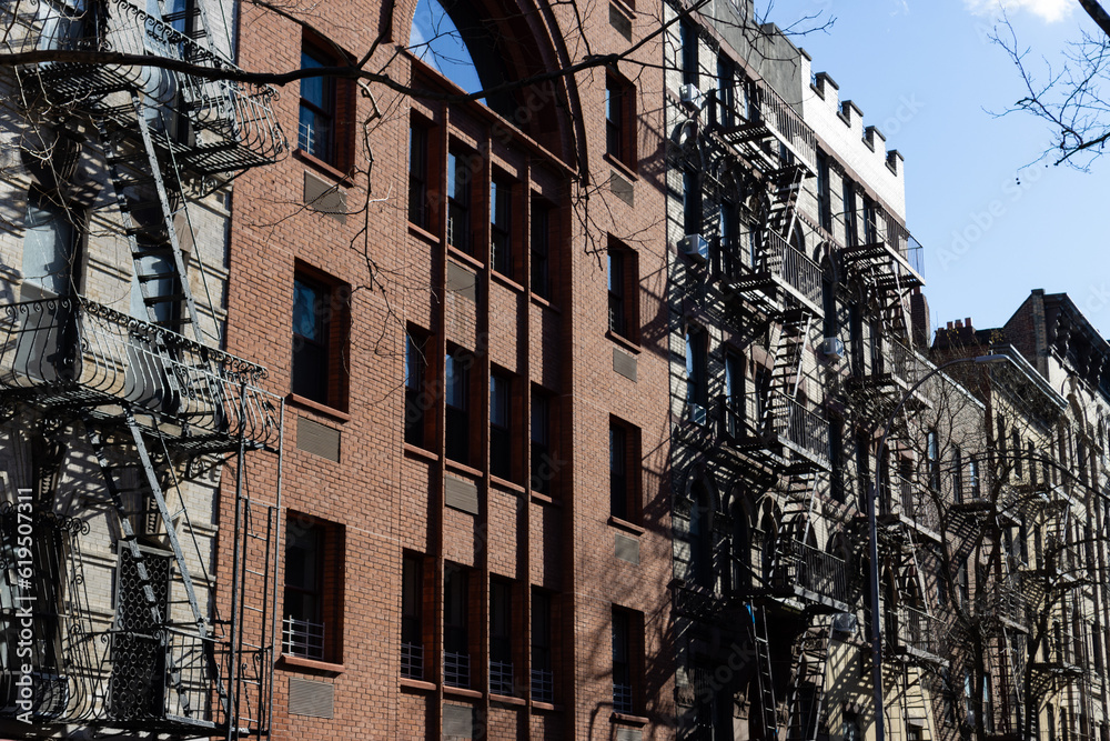 Row of Old Brick Apartment Buildings with Fire Escapes along a Residential Street in Greenwich Village of New York City