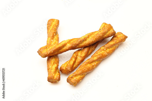 Few salty and  twisted pretzel sticks isolated on white background. Italian snack photo