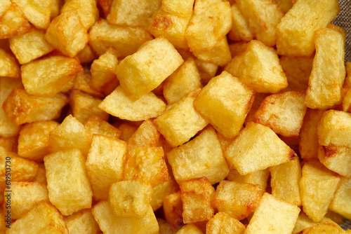 Dice sliced fried potatoes close up