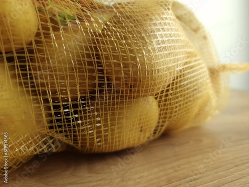Raw potatoes in net pack