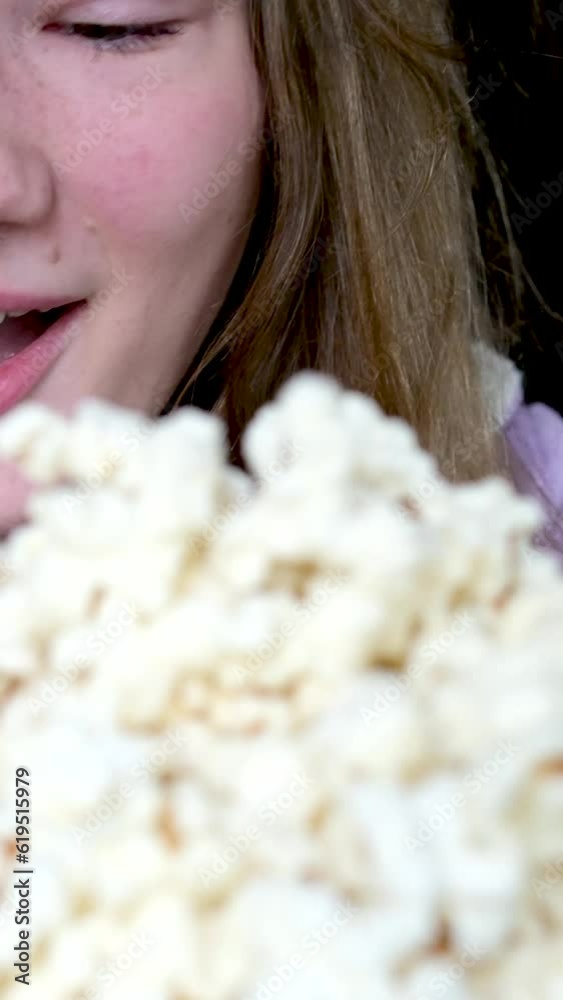 close-up slow motion video pouring a lot of popcorn scatters in different directions girl rejoices laughs looks at it, happy expression of a child of a young woman teenager smile sincere laughter close-up slow motion video pouring a lot of popcorn scatters in different directions girl rejoices laughs looks at it, happy expression of a child of a young woman teenager smile sincere laughter