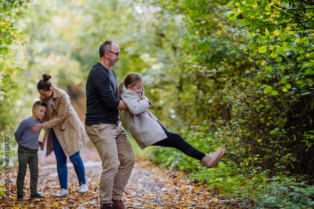 Fototapeta premium Happy family having fun with kids in a forest.