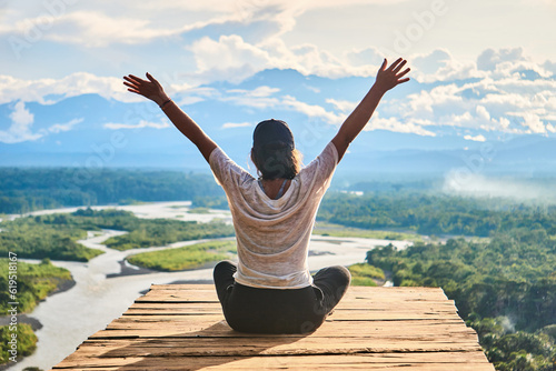 Unrecognizable woman enjoying freedom over wooden board on mountain photo