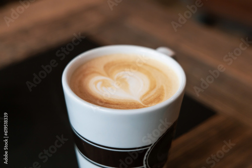 Hot drinks. A cup of caffe latte or cappuccino on a table in a cafe.