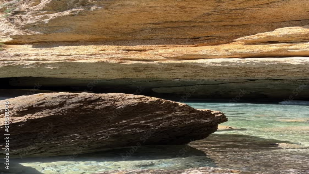 Rocks in the sea cave, vertical video. Water light reflections on the stone. Rocks in the sea cave, vertical video. Water light reflections on the stone.