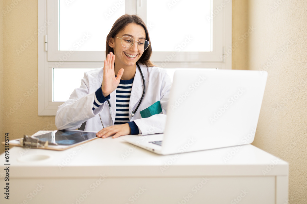 Cheerful doctor having online video consultation Cheerful doctor having online video consultation