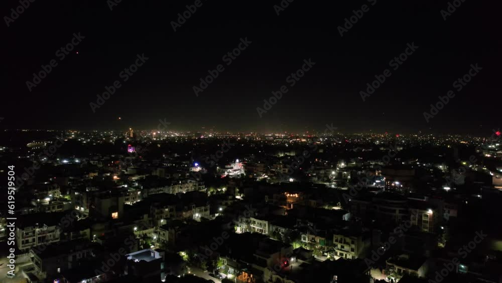 aerial drone tripod shot showing cityscape of jaipur delhi with fireworks, rockets, pyrotechnics and sky lanterns at night in celebration of makar sankranti, independence republic day and diwali in
