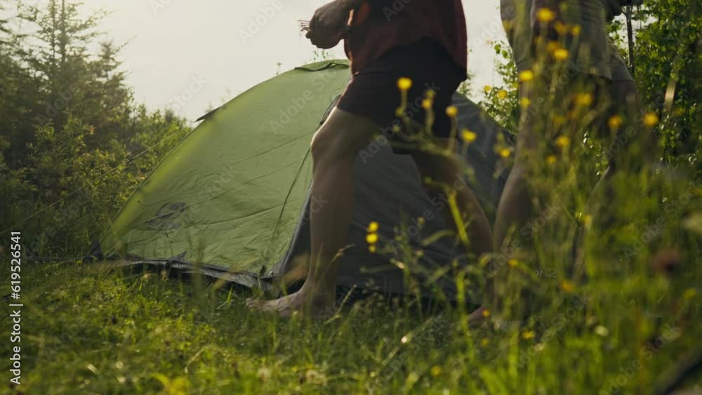 Vacation, Two tourists set up a tent in a forest area to spend the night In mountainous area. Fitness woman Resting from everyday routine work mastering new techniques testing herself in the wild, man
