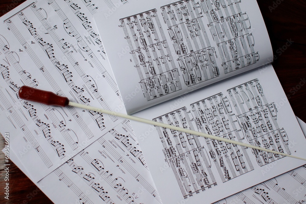 Conductor baton on music score close-up Conductor baton on music score close-up