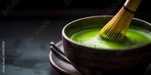Macro shot of a vibrant green matcha tea in a black ceramic bowl, showing the texture and vivid color of the tea, a bamboo whisk, soft natural light