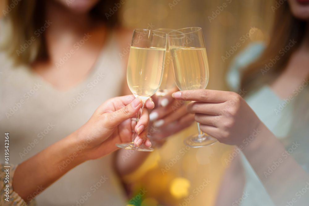 Group of friends celebrating with champagne  Close up on hands.