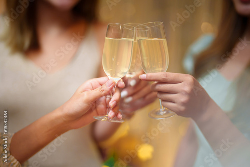 Group of friends celebrating with champagne  Close up on hands.