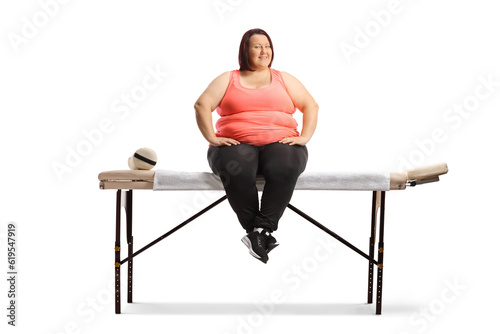 Overweight woman sitting on a massage table