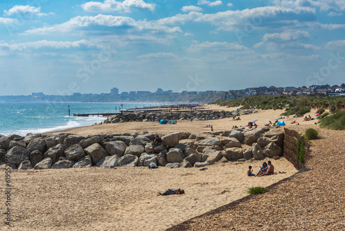 Hengistbury Head, UK - June 3rd 2023: The Rock groynes and people on Hengistbury Head Beach. photo