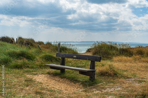 Warren Hill, Hengistbury Head, UK - July 1st 2023: Memorial bench with the sea in the background.
