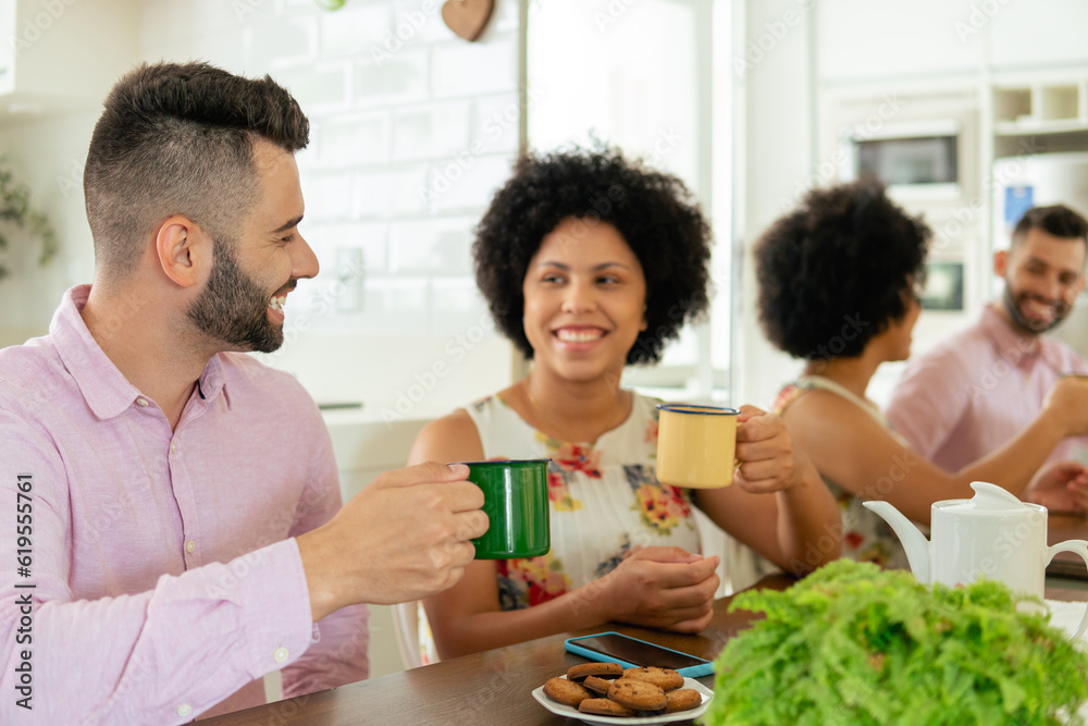 brazilian couple drinking coffee and eating snacks at table brazilian couple drinking coffee and eating snacks at table
