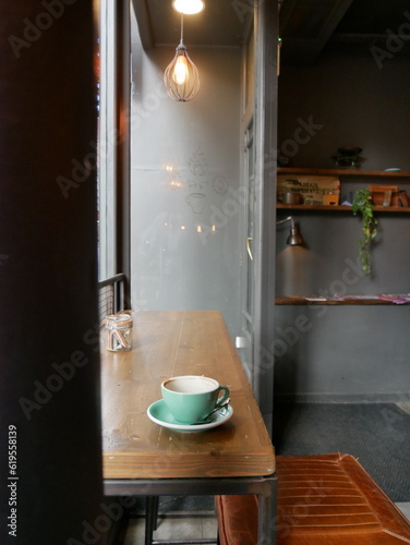 Empty coffee cup on wooden table in cafe window
